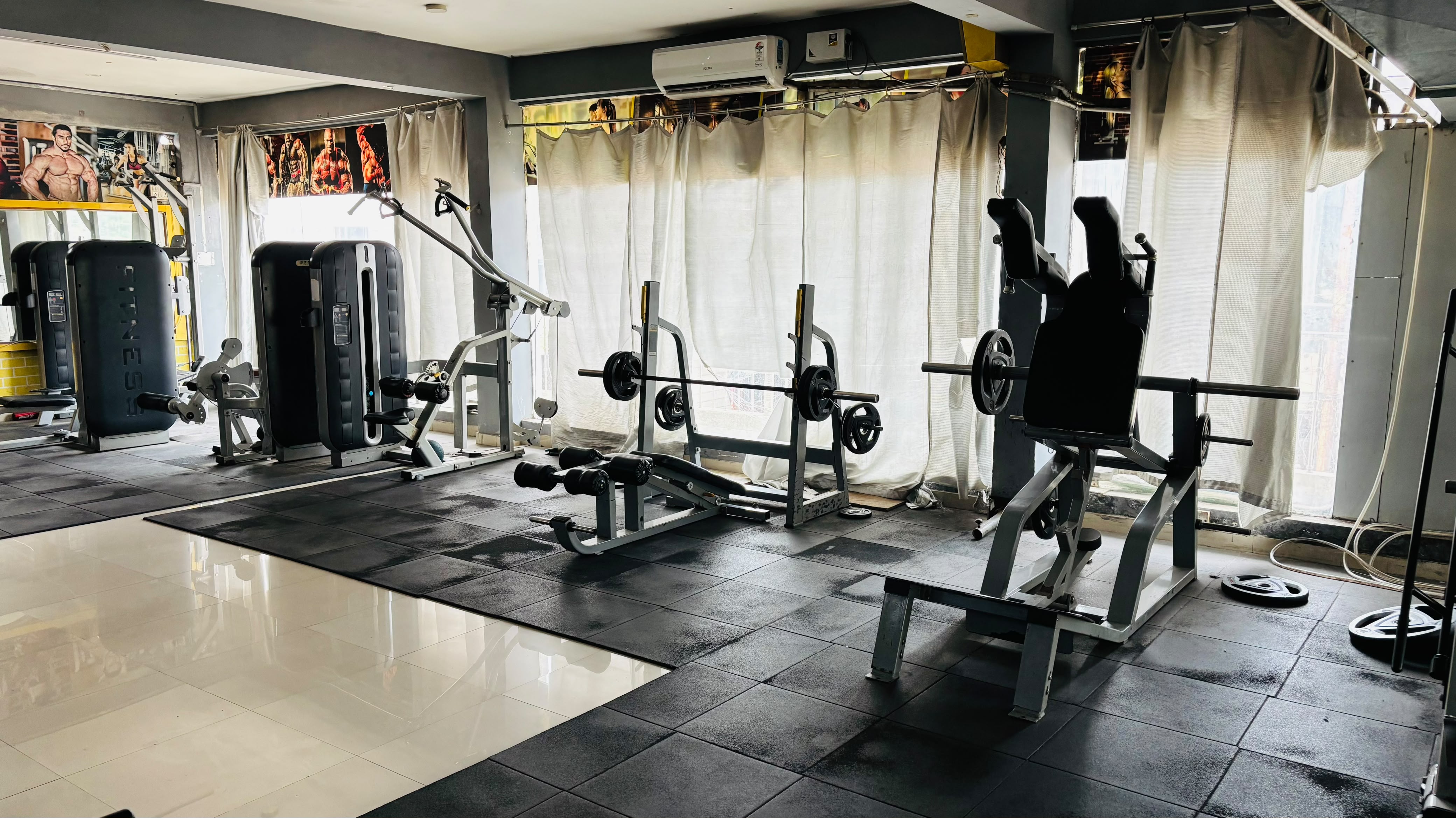 Wide gym interior with premium strength training setup